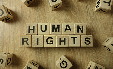 image: wooden blocks spelling words "Human Rights" (iStockphoto)
