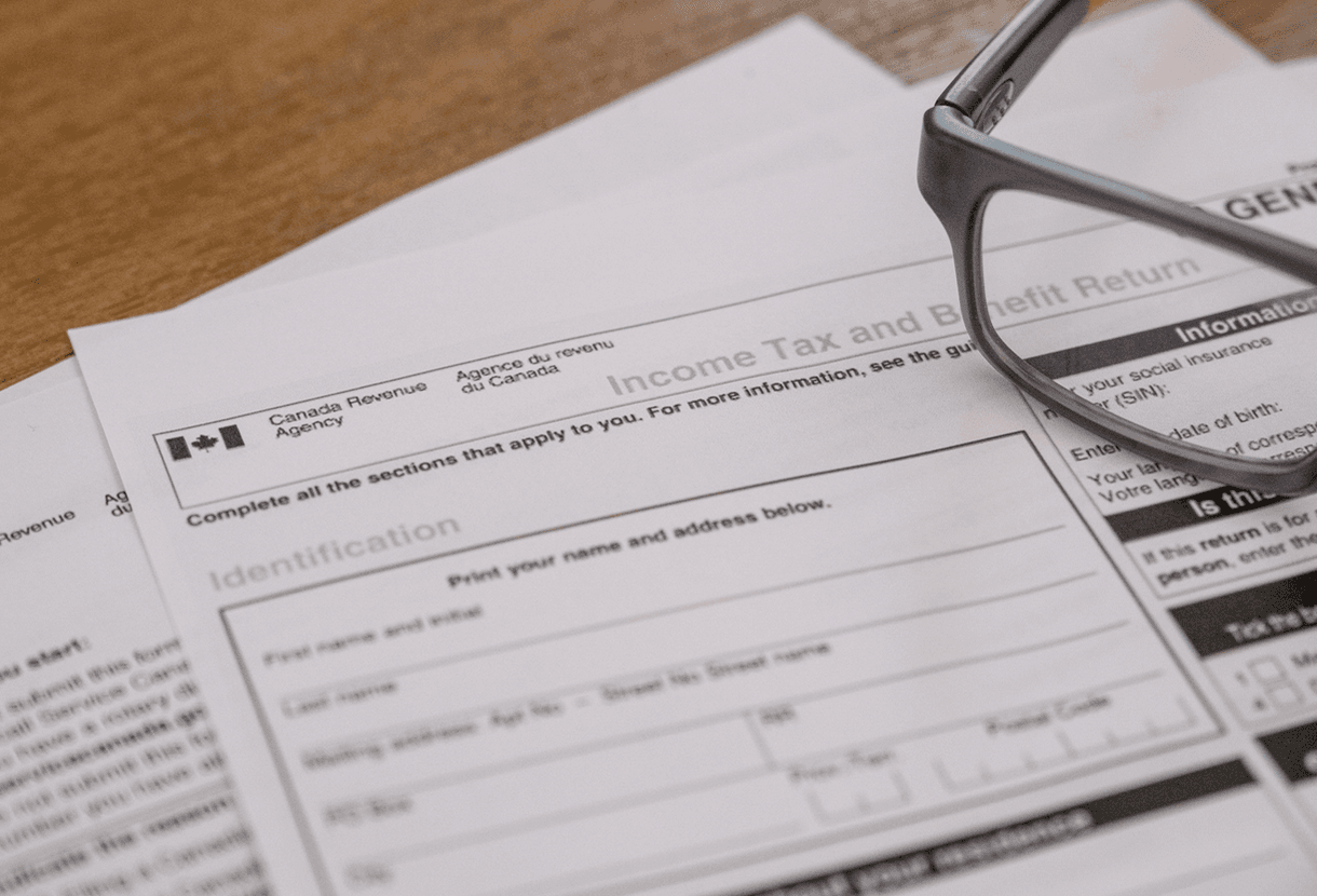 photo - eyeglasses on top of Canadian income tax forms (iStockphoto)