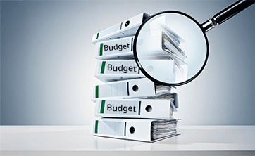 image: a stack of binders labelled "budgets" (iStockphoto)