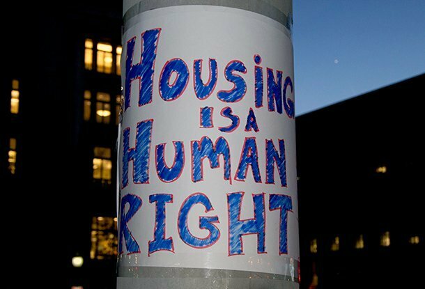 Housing is a Human Right poster on a street light