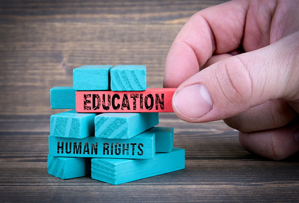 photo: bricks with words "Education" and "Human Rights"