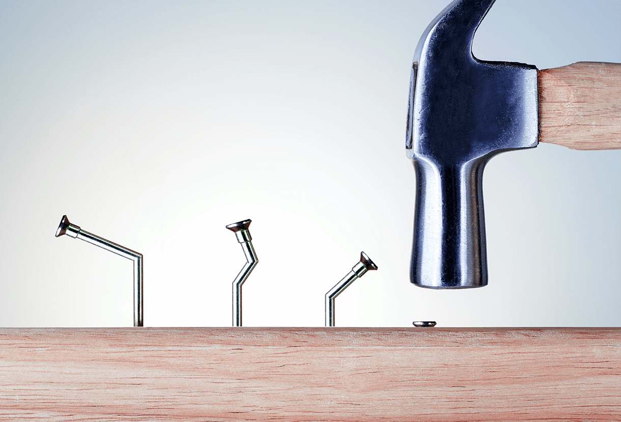image: bent nails with a final successfully hammered-in nail (iStockphoto)
