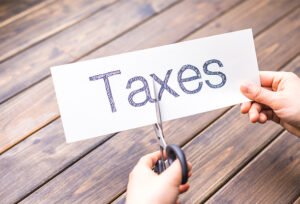 Cut paper with word taxes by scissors (iStockphoto)