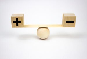 photo: plus and minus blocks balanced on a teeter-totter (iStockphoto)