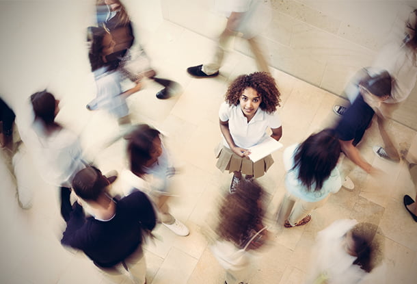 Female youth surrounding by blurred fellow students (iStockphoto)